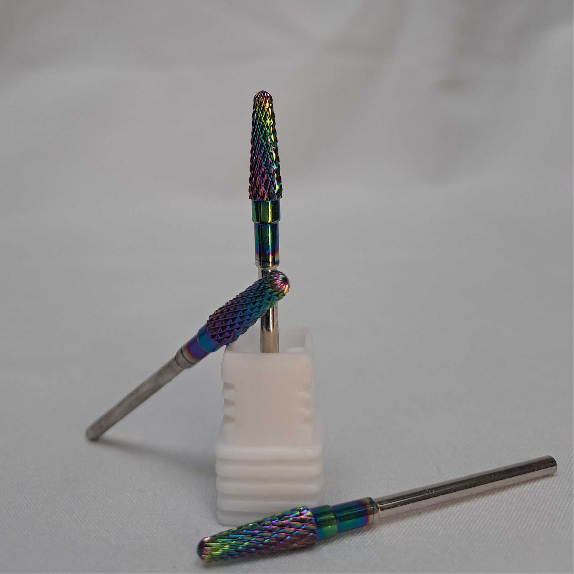 Two dental burs with colorful handles on a white background