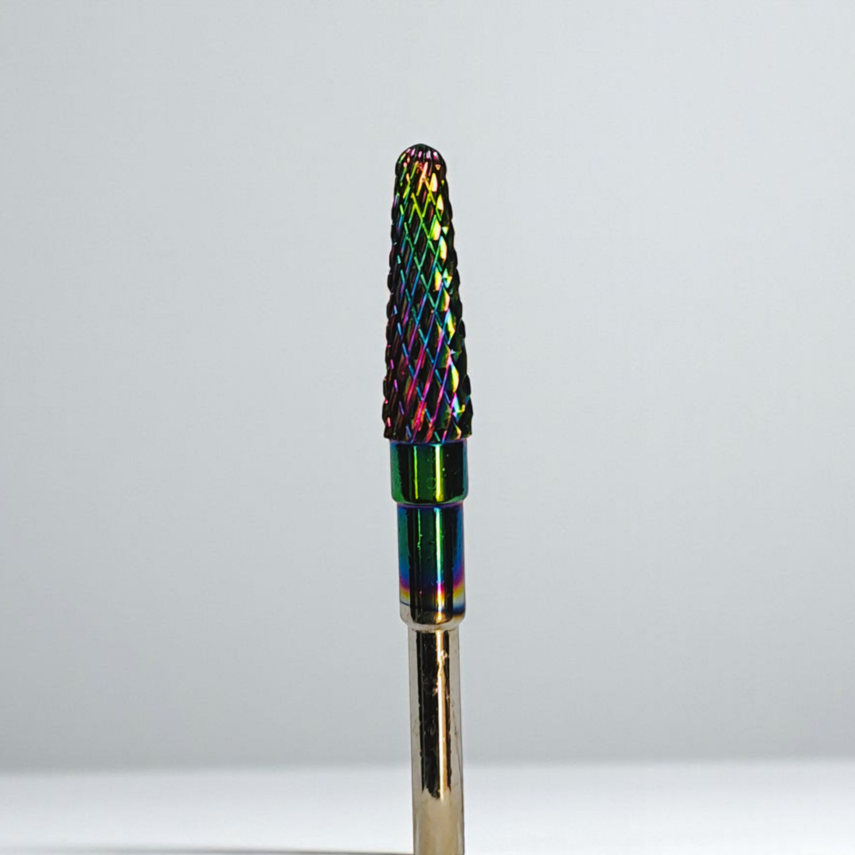 Multicolored nail drill bit on a white background