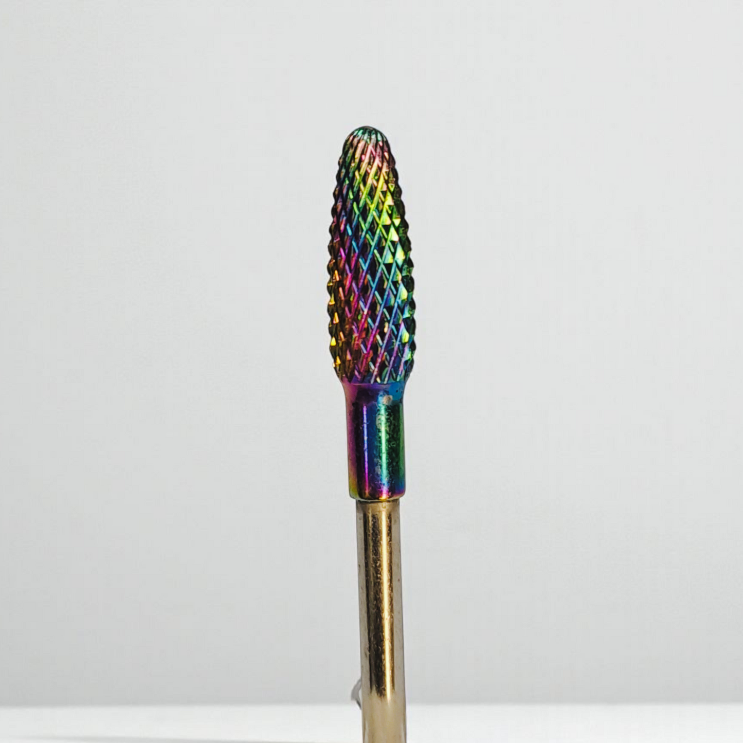 Multicolored nail drill bit on a white background