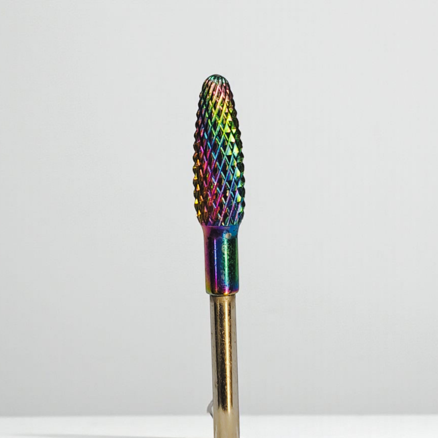 Multicolored nail drill bit on a white background