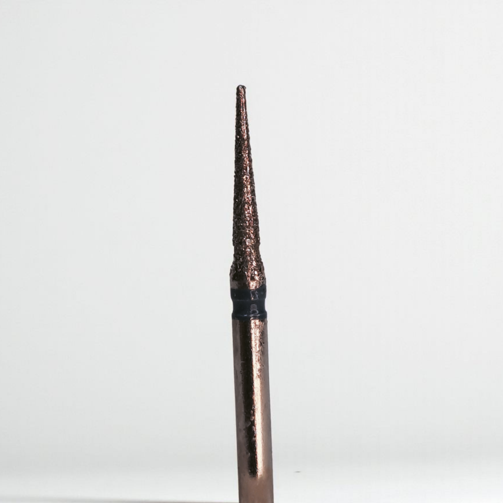 Bronze-colored pen cap with black band on a white background